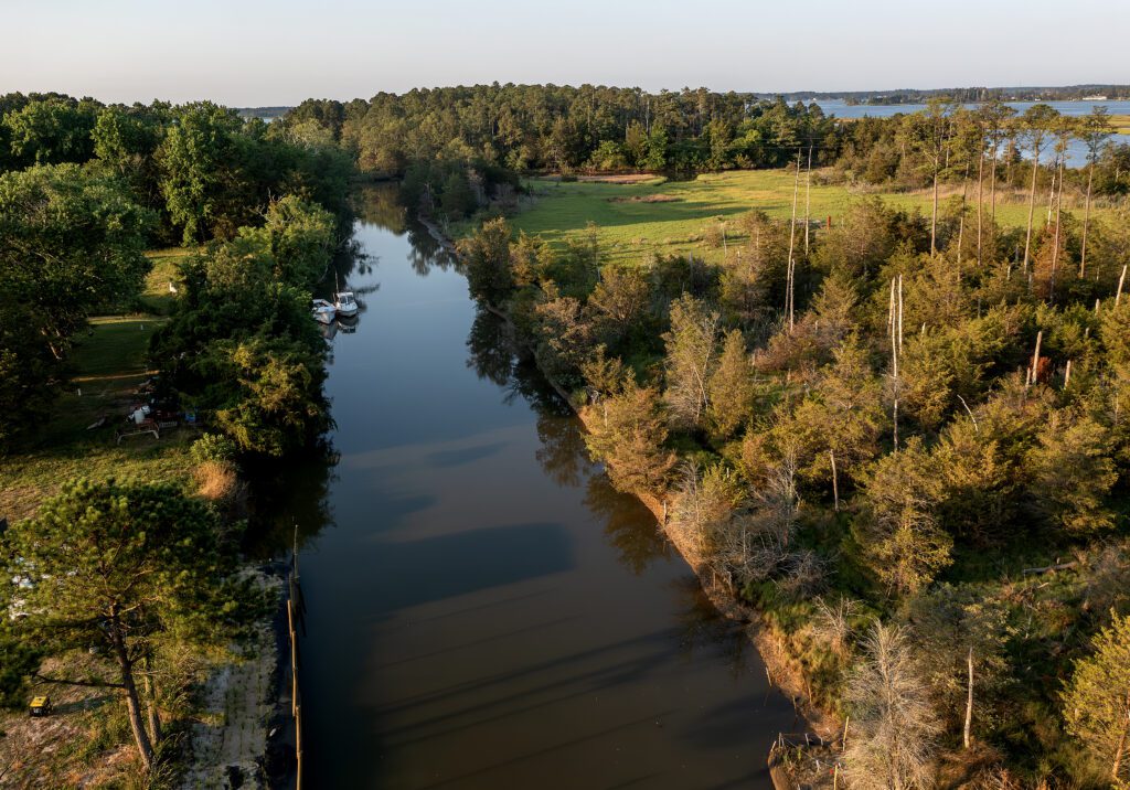 A quiet canal and tree-lined marshland adjacent to the trail system at Captain Sinclair’s.